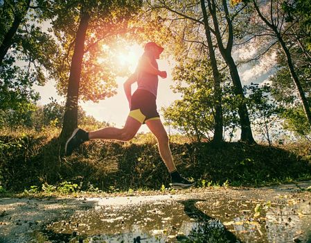 Man jogger run in park sunny day nature background. Man training, prepare his body for marathon