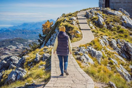 Woman traveller in mountain landscape at national park Lovcen, Montenegro. Travel to Montenegro concept.