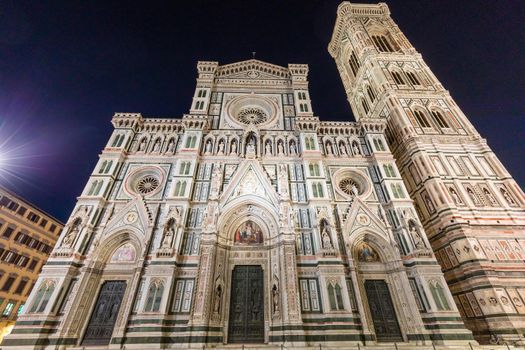 Florence, Italy - Circa August 2021: Florence by night. The  illuminated architecture of the famous cathedral exterior.