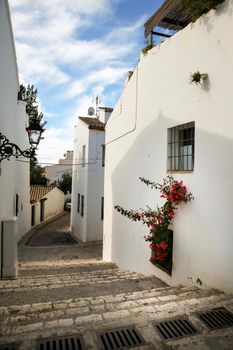 Beautiful whitewashed facades with colorful bougainvillea plant in Altea village, Alicante, Spain