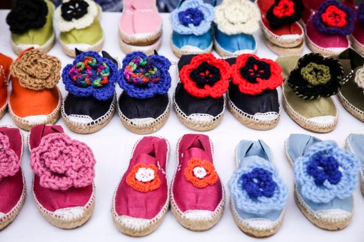 Colorful handmade esparto shoes for sale at a market stall