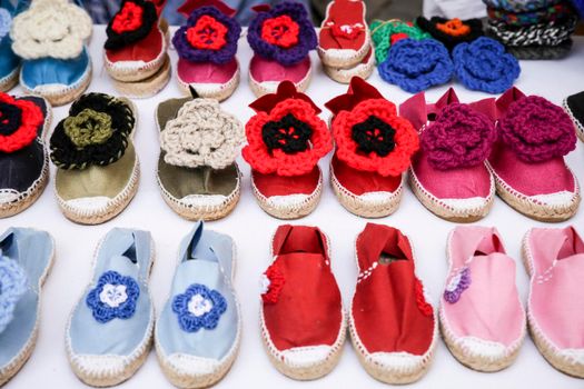 Colorful handmade esparto shoes for sale at a market stall