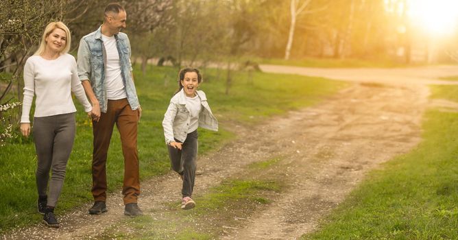 Family and small child outdoors in spring nature, resting