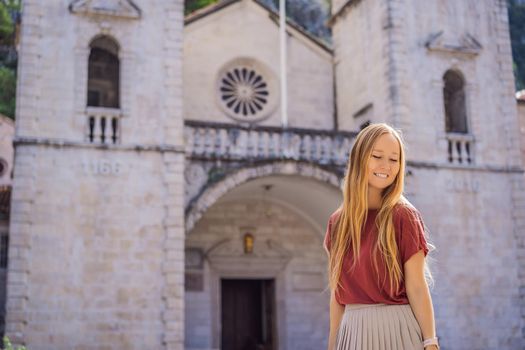 Woman tourist enjoying Colorful street in Old town of Kotor on a sunny day, Montenegro. Travel to Montenegro concept.