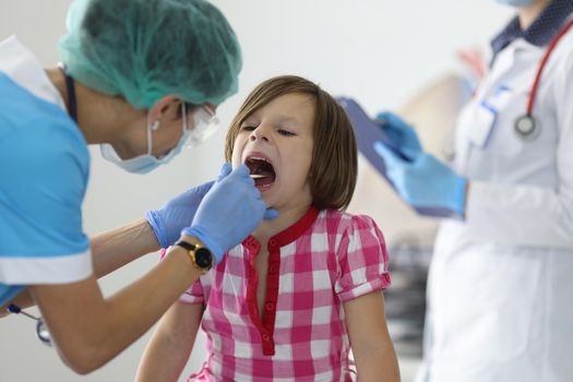 Close-up of female nurse, takes cotton bud to analyze saliva, nasal swab, mucous membrane for DNA tests. COVID-19, determination paternity or presence of virus