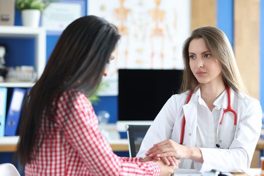 Portrait of female patient at doctor appointment, incurable disease. Doctor calming down upset woman. Healthcare and medicine concept