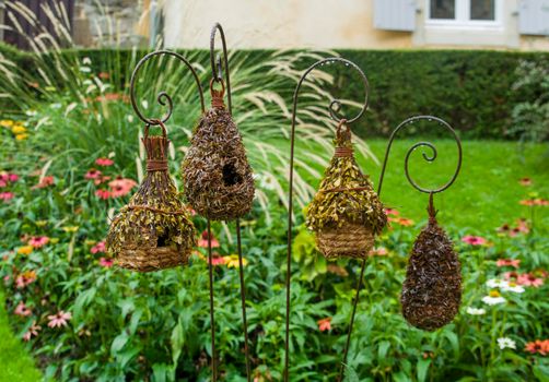 Straw birdhouses are suspended in the garden Handemade
