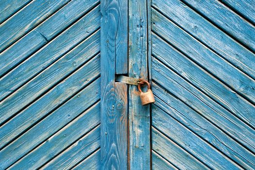 Old padlock on a vintage retro wooden door