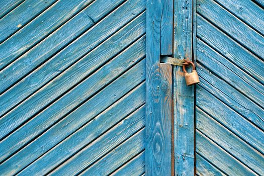 Old padlock on a vintage retro wooden door