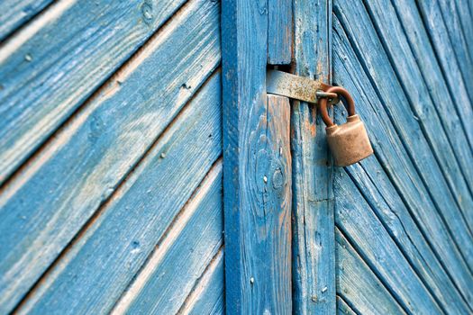 Old padlock on a vintage retro wooden door