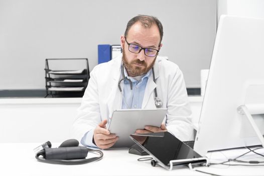 Doctor using his tablet computer at work. High quality photo