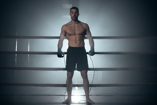Boxer jumping rope in boxing ring. High quality photo