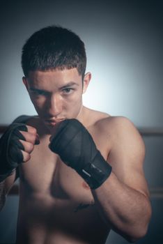 Mixed martial arts fighter posing in a ring. High quality photo