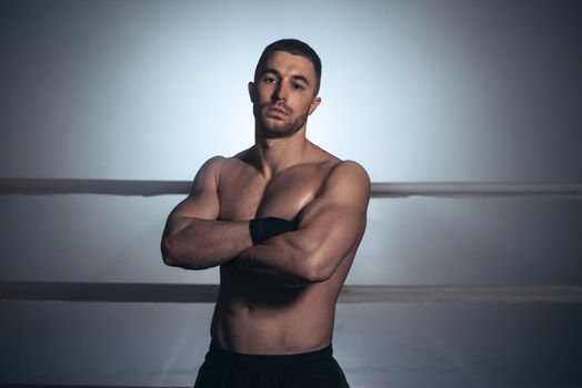 Mixed martial arts fighter posing in a ring. High quality photo