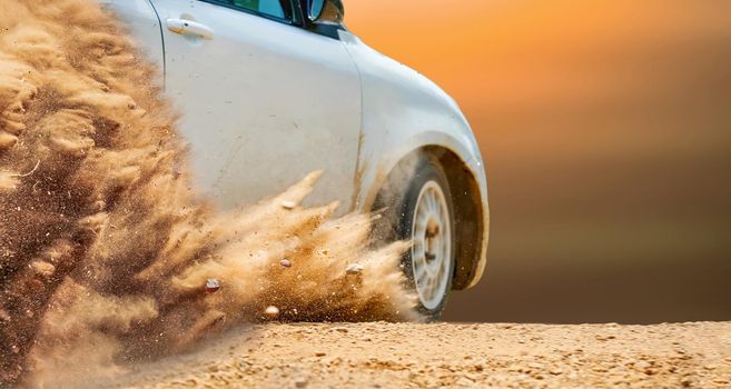 Rally race car drifting on dirt track.