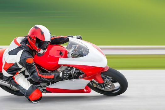 Motorcycle practice leaning into a fast corner on track