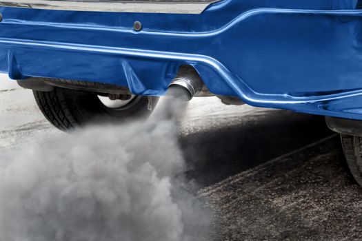 Air pollution from vehicle exhaust pipe on road