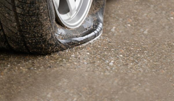 Flat tire car on side of street because expired tyre