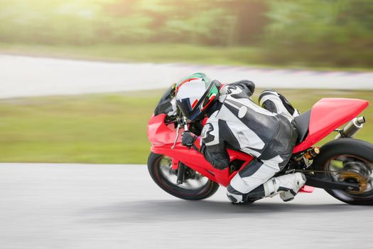 Motorcycle practice leaning into a fast corner on track.