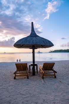 luxury travel, romantic beach getaway holidays for honeymoon couples, tropical vacations in a luxurious hotel, and beach chairs on the beach.