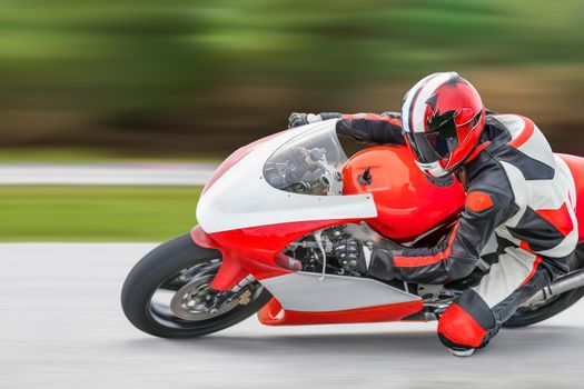 Motorcycle practice leaning into a fast corner on track