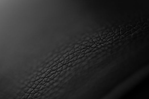 The structure of dermantine fabric close-up. Selective focus. Abstract dark background with gradient. Backdrop