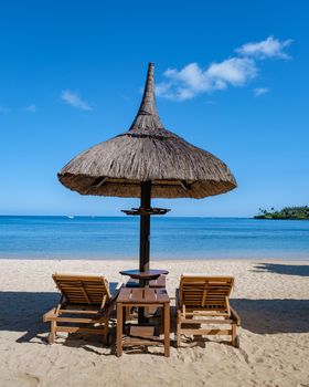 luxury travel, romantic beach getaway holidays for honeymoon couples, tropical vacations in a luxurious hotel, and beach chairs on the beach.