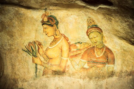 Wall painting (frescoes) in Sigiriya an ancient rock fortress , Apsara celestial nymphs - ancient painting on the walls in the Lion Rock cave, Sigiriya, Sri Lanka