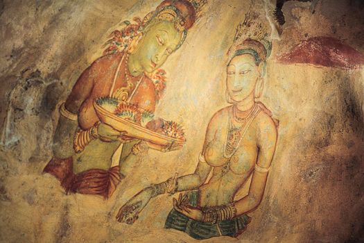 Wall painting (frescoes) in Sigiriya an ancient rock fortress , Apsara celestial nymphs - ancient painting on the walls in the Lion Rock cave, Sigiriya, Sri Lanka