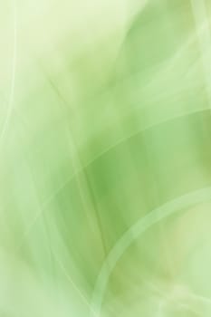 Abstract vertical banner background in shades of green. Backdrop with a smooth gradient and waves resembling leaves.