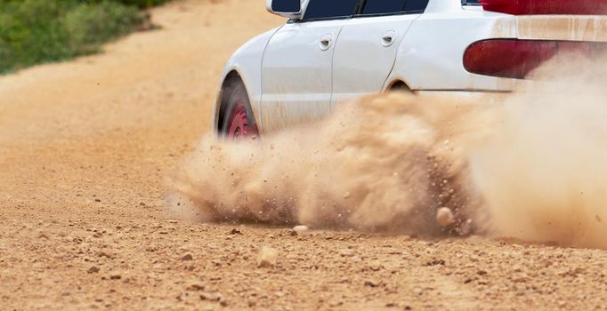 Rally race car drifting on dirt track.