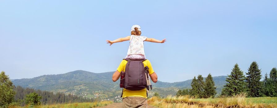 Piggyback ride father child travel mountain kids freedom child on shoulders dad and daughter father walking hiking trip nature kid arms spread out. Freedom mountain children hiking trail walking hills.