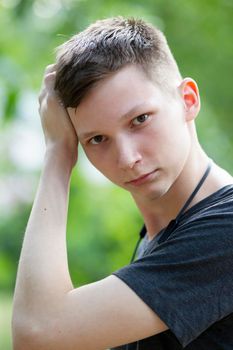 Belarus, city of Gomil, June 20, 2019. Street in the city. A young man looks into the camera. Boy at seventeen.