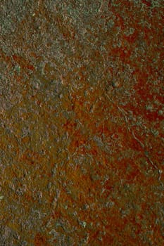 Old cracked red paint on old plaster in dirty green tones. Vintage vertical background banner.