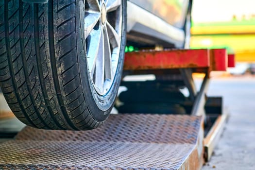 Replacing a car wheel at a tire station. a rubber covering, typically inflated or surrounding an inflated inner tube, placed around a wheel to form a flexible contact with the road.