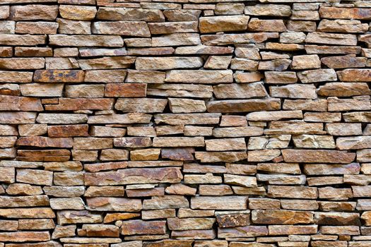 Part of a sandstone stone wall, expressive texture and background in high resolution.