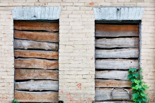 Boarded up window openings, weathered plank texture, close-up, image with copy space.