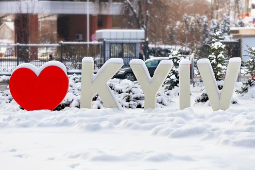 The inscription "I love Kyiv" in the city park park under a cap of snow in winter. Kyiv, Ukraine. 16.01.2021.