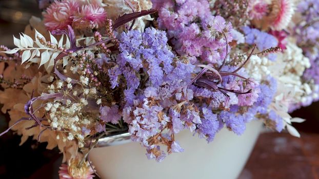 Bouquets with white, purple and violet dried flowers and leaves for sale in flower shop. Assortment for decoration and congratulation