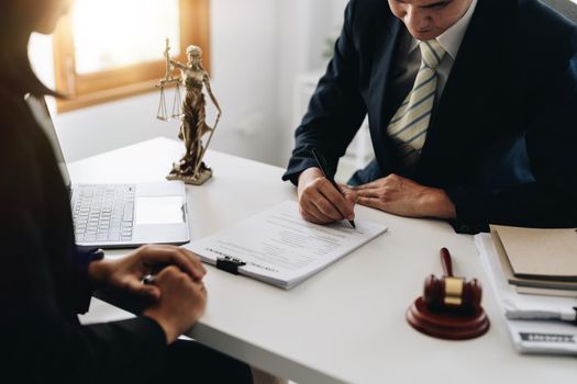 lawyer or judge is giving legal advice. to explaining about consultation terms and conditions to businessmen before signing on contract at a law firm.