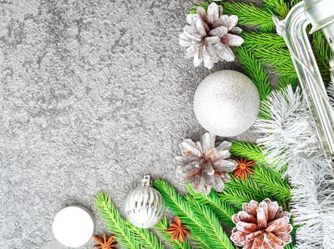 Christmas and Happy New Year gray stone background. Top view, copy space, a military stile. Fir branches, silver concrete