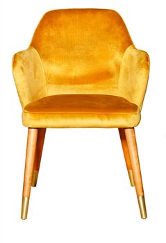 Beautiful comfortable soft armchair with golden velor upholstery, wooden legs and gilded tips, isolated on white background.