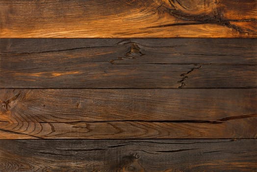 Old, cracked wood background and dark brown texture with cracks and knots, high resolution.