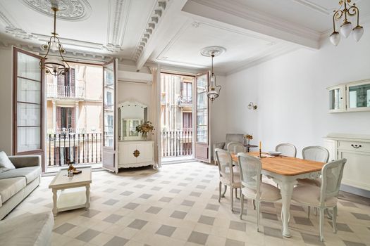 Beautiful bright interior. Classic room with tile floor, light walls, balconies and vintage elements of decoration.