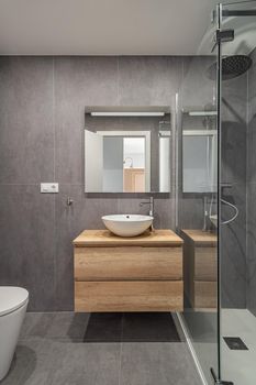 Stylish bathroom interior with countertop, mirror and shower. Minimalist style