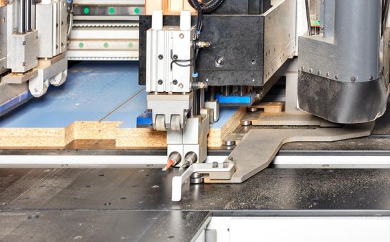 Edging on a pneumatic line of an automatic drilling and milling woodworking machine for the manufacture of cabinet furniture from chipboard.
