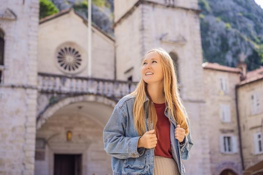 Woman tourist enjoying Colorful street in Old town of Kotor on a sunny day, Montenegro. Travel to Montenegro concept.