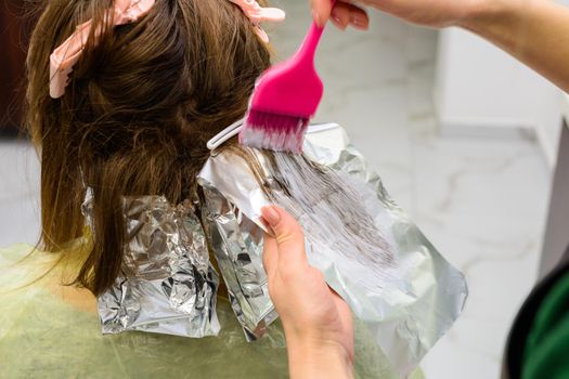 Beginning of hair coloring, coloring technique balayag, hair bleaching for applying paint. new