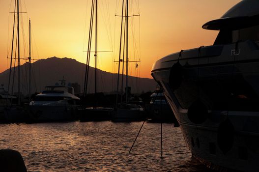 Olbia, Sardinia / Italy - 2019/8/21: Panoramic view of marina di Olbia port and yacht marina at sunset