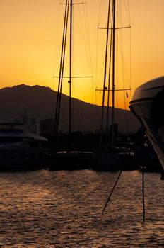 Olbia, Sardinia / Italy - 2019/8/21: Panoramic view of marina di Olbia port and yacht marina at sunset